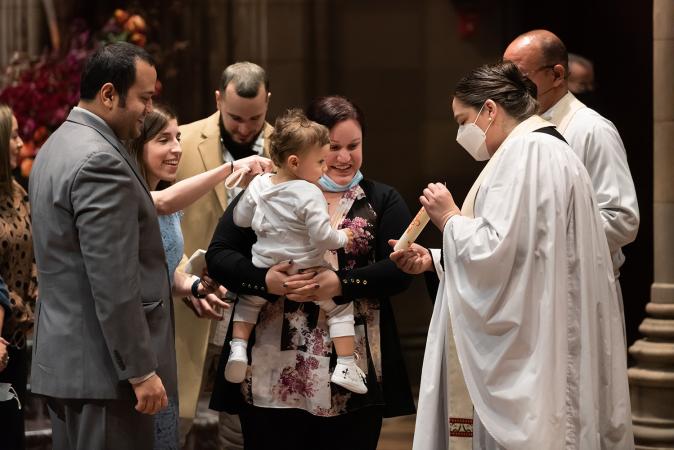 A child is blessed in Trinity Church on All Saints Sunday 2021