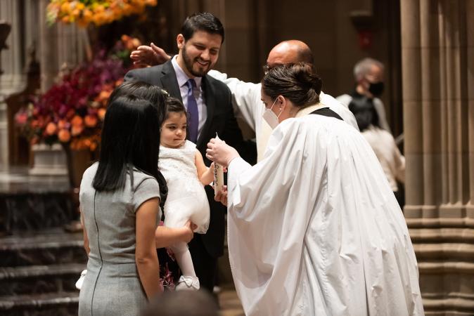 A child is blessed in Trinity Church on All Saints Sunday 2021