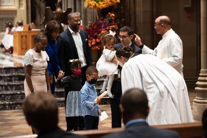 A child is blessed in Trinity Church on All Saints Sunday 2021