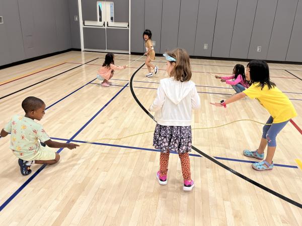 Children play in the Trinity Commons gym during the 2023 Summer Program