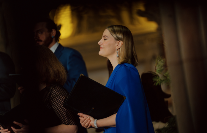 Profile view of a female choir member in a blue dress.