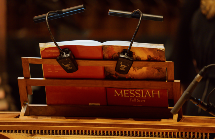 An open score rests on a music stand.