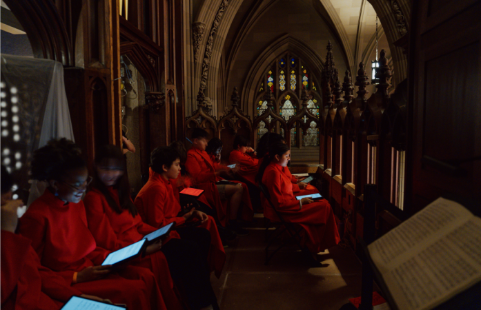 Members of Trinity Youth Chorus are seated in the choir loft before the performance.