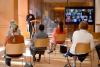 Members of the congregation sit in chairs with WebEx screen and Vicar speaking at Discovery