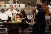 A child is baptized in Trinity Church on All Saints Sunday 2021