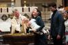 A child is baptized in Trinity Church on All Saints Sunday 2021