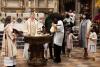 A child is baptized in Trinity Church on All Saints Sunday 2021