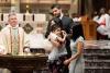 A child is baptized in Trinity Church on All Saints Sunday 2021