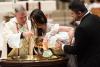 A child is baptized in Trinity Church on All Saints Sunday 2021