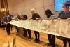 Rabbi Darren Levine rolls up a Torah scroll held by Into the Word participants, February 1, 2024