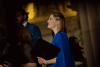 Profile view of a female choir member in a blue dress.