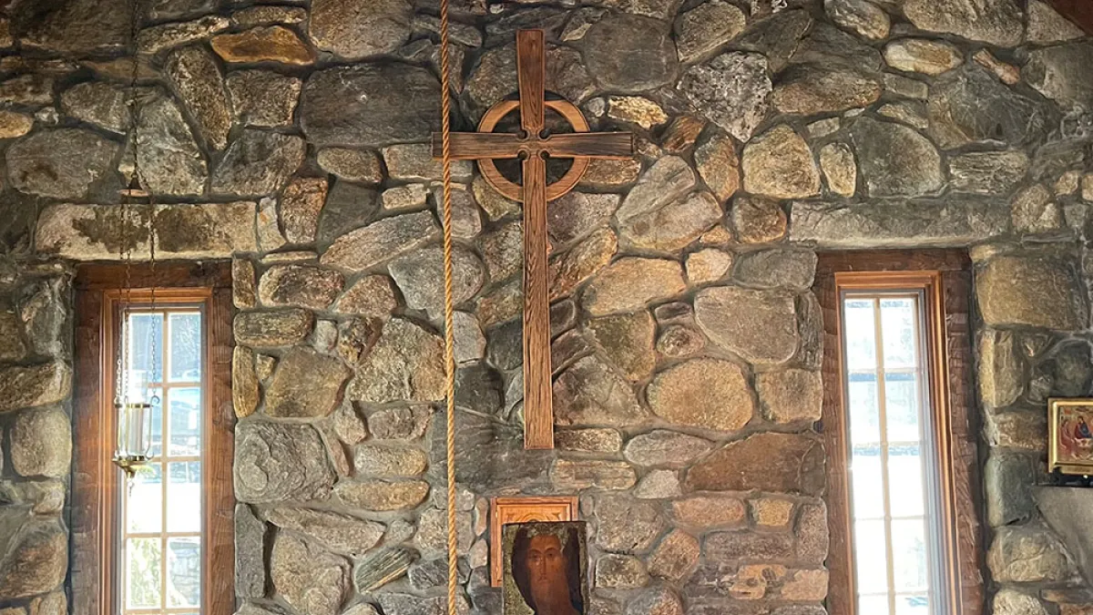 Trinity Retreat Center stone chapel is shown with light streaming in the windows