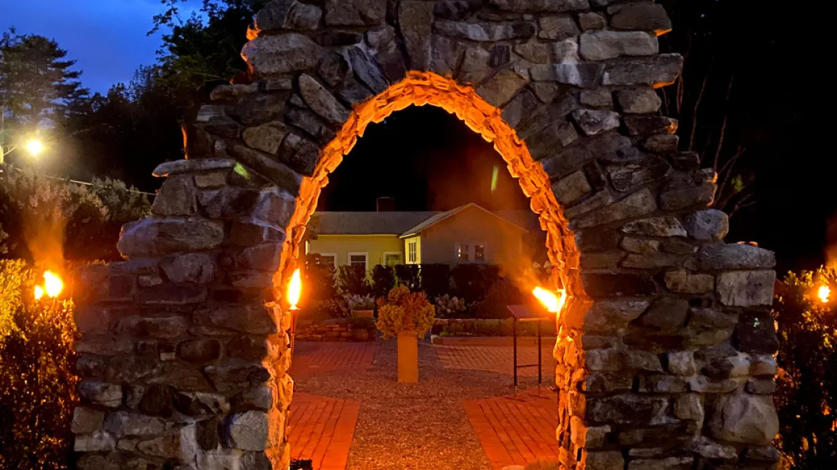 The top of the Retreat Center's stone arch in the early evening