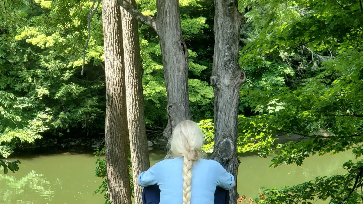 Woman with a braided ponytail overlooks the bank of the Housatonic River