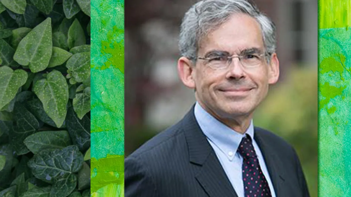 Headshot of Michael Gerrard in a suit on a green background