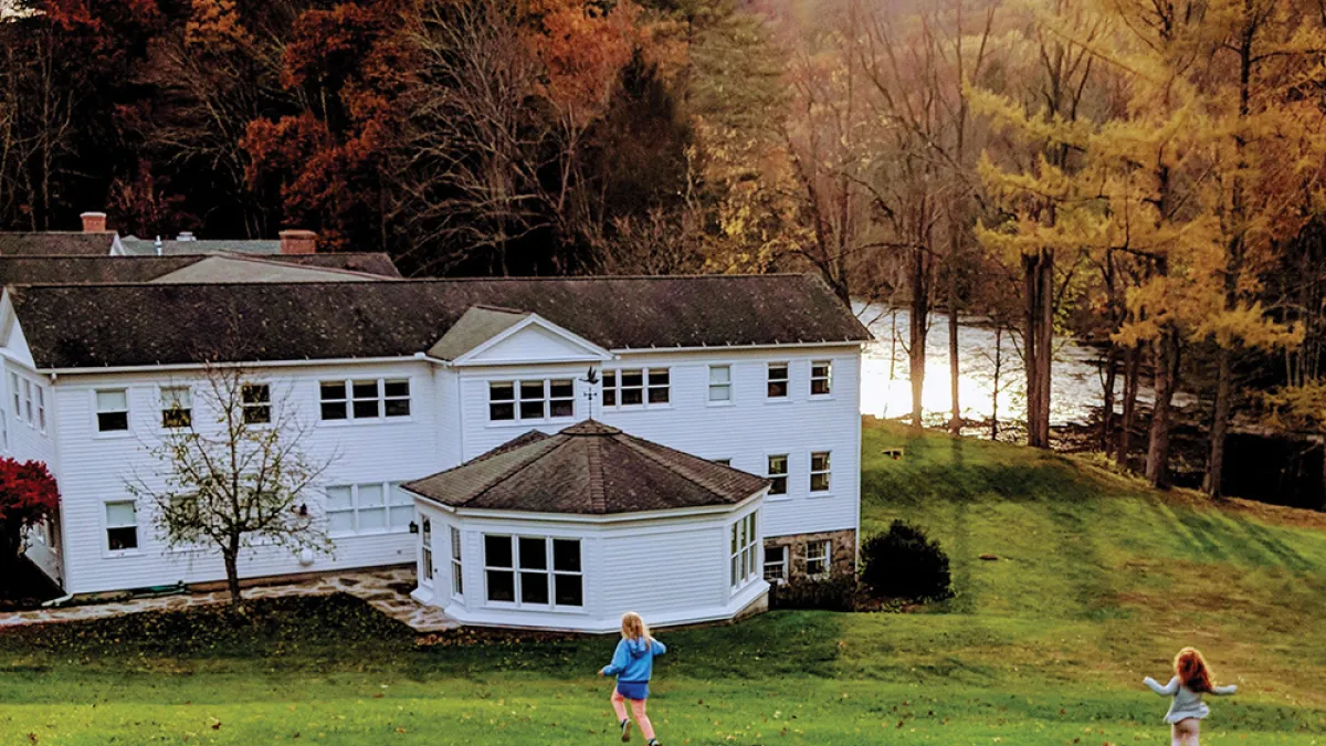 Two children running down a hill