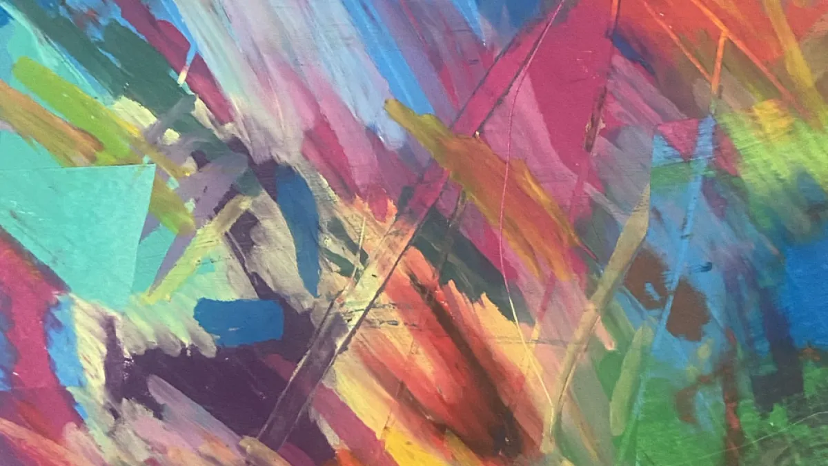 A rainbow of oil pastel strokes layered over each other