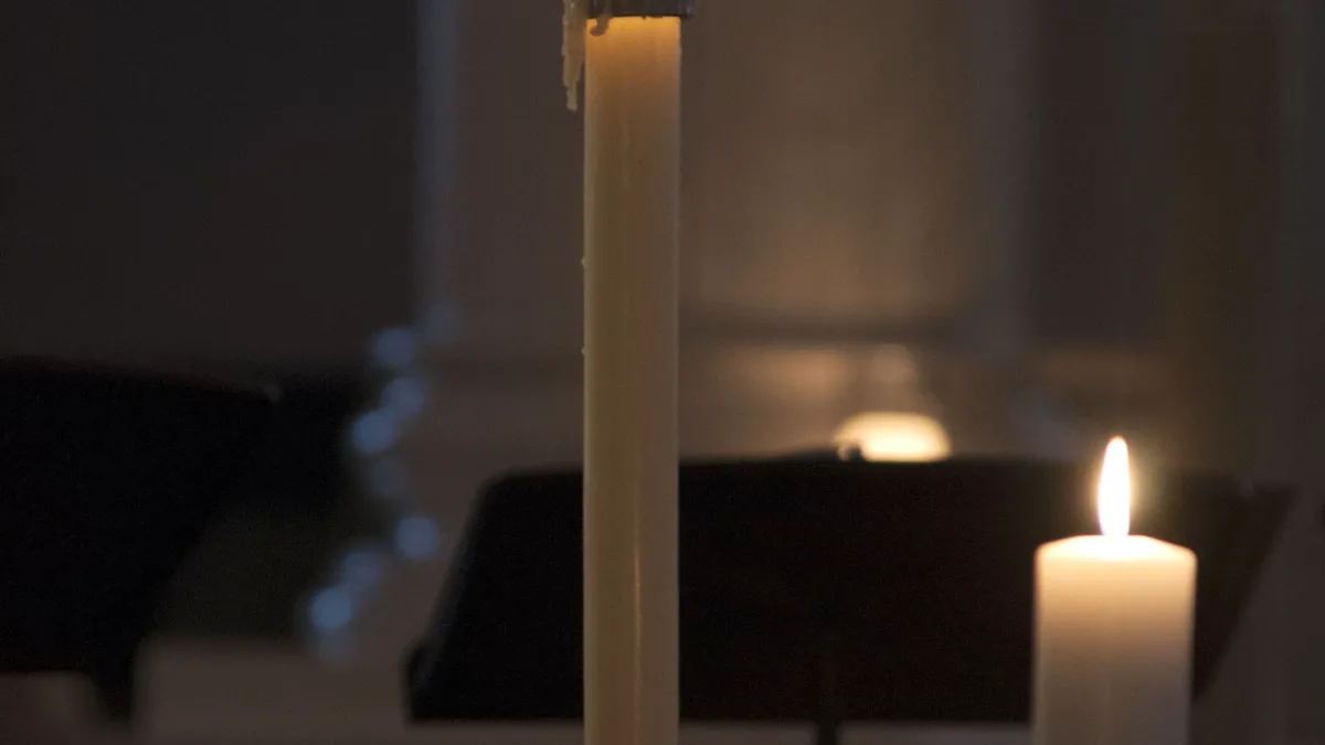 Candles glow in the darkness in St. Paul's Chapel