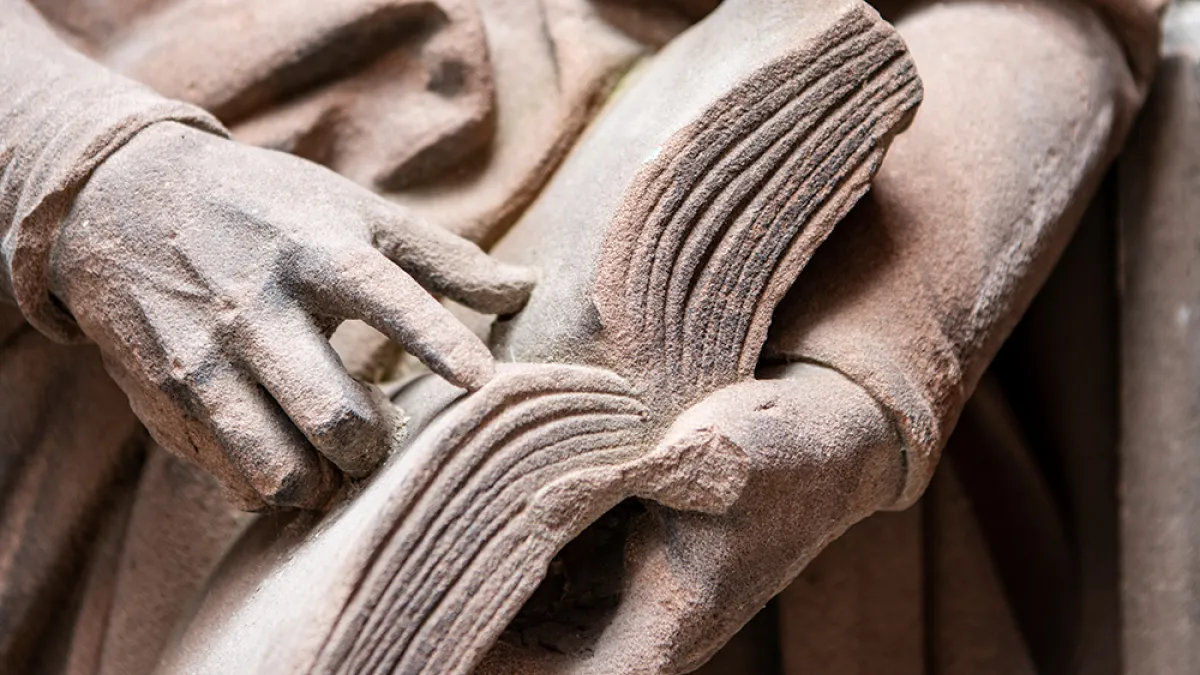 Statue holding a book