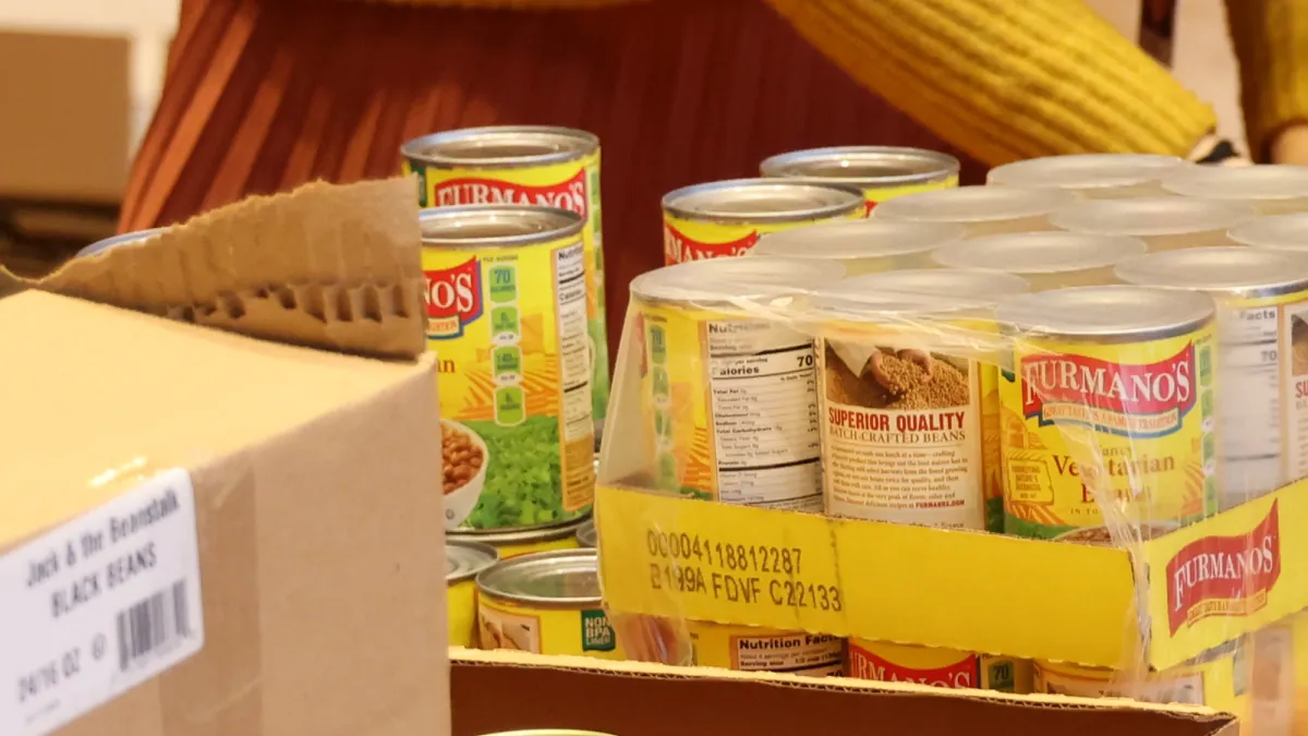 Image of volunteer packaging cans of food