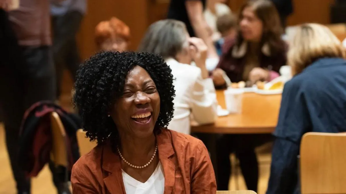 A woman is laughing at a class