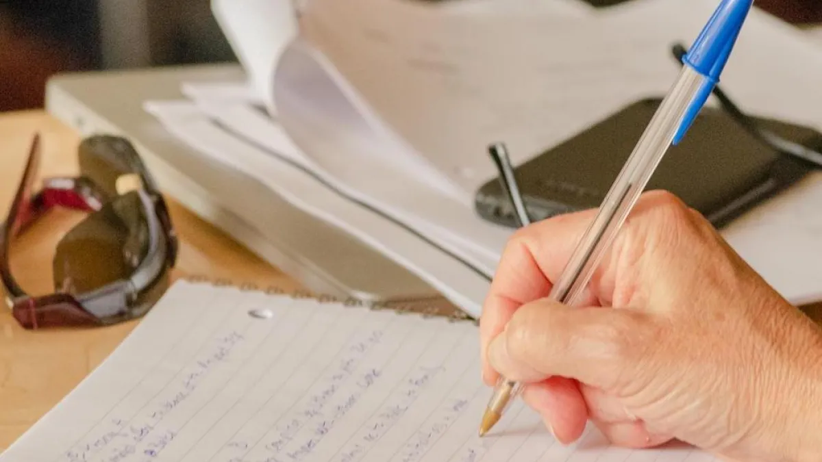 Someone is writing in the notebook