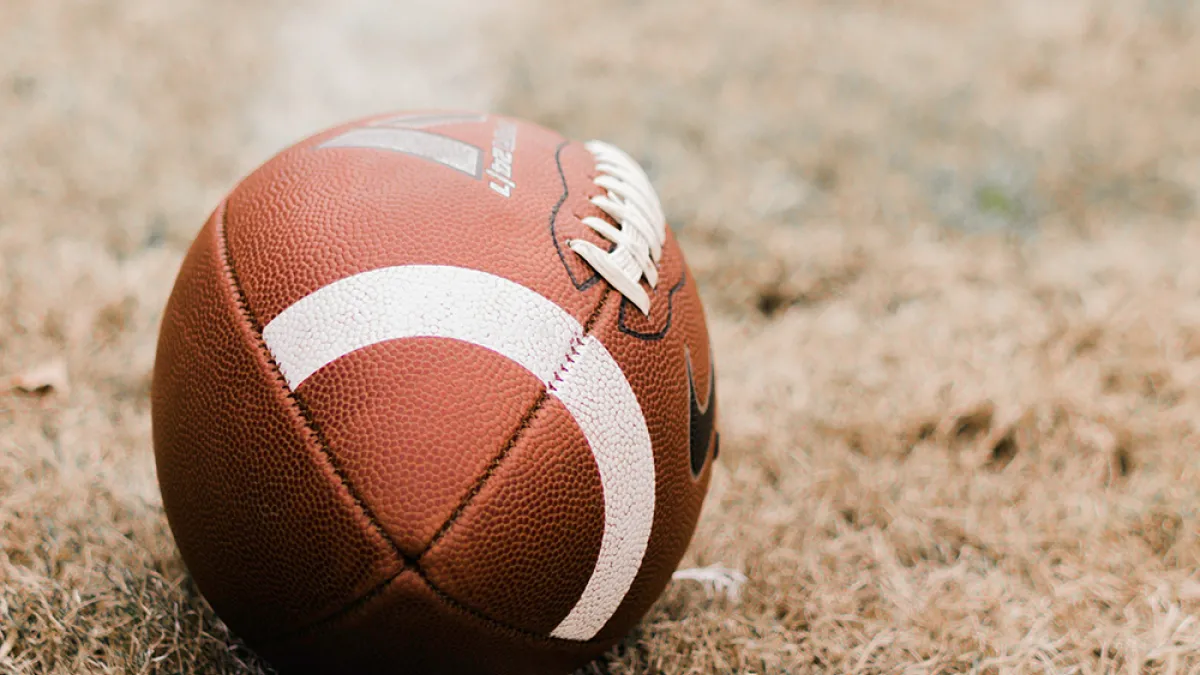 A football on a grass field.