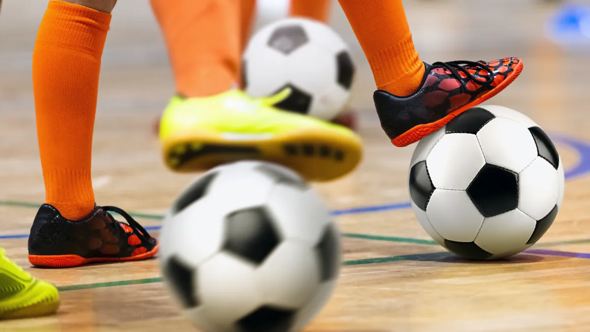 Close up shot of people playing with soccer balls.