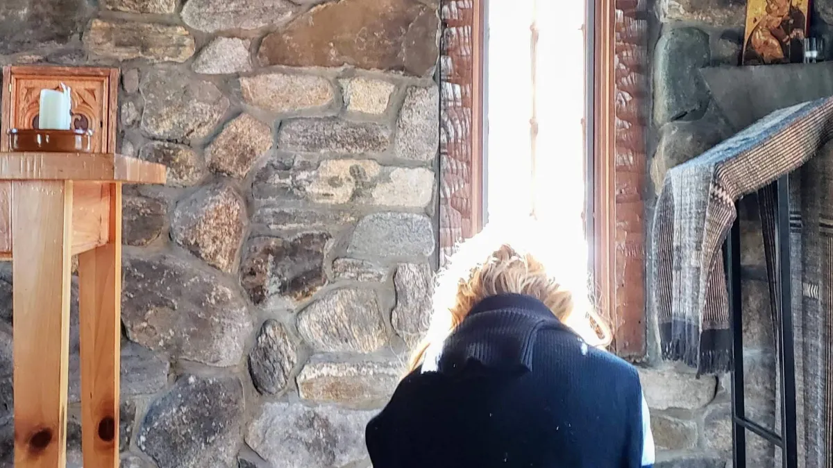Woman praying in chapel