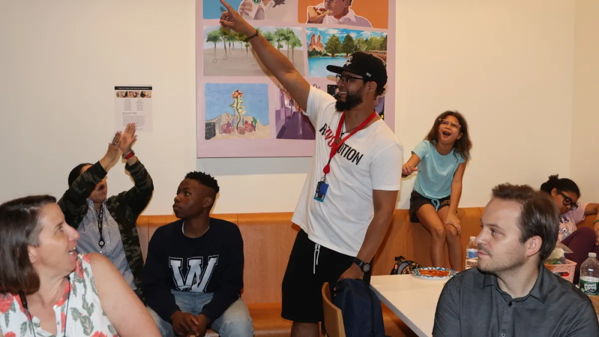 Members of Trinity Youth and staff clap at the Trinity Youth End-of-Year Celebration 2023.