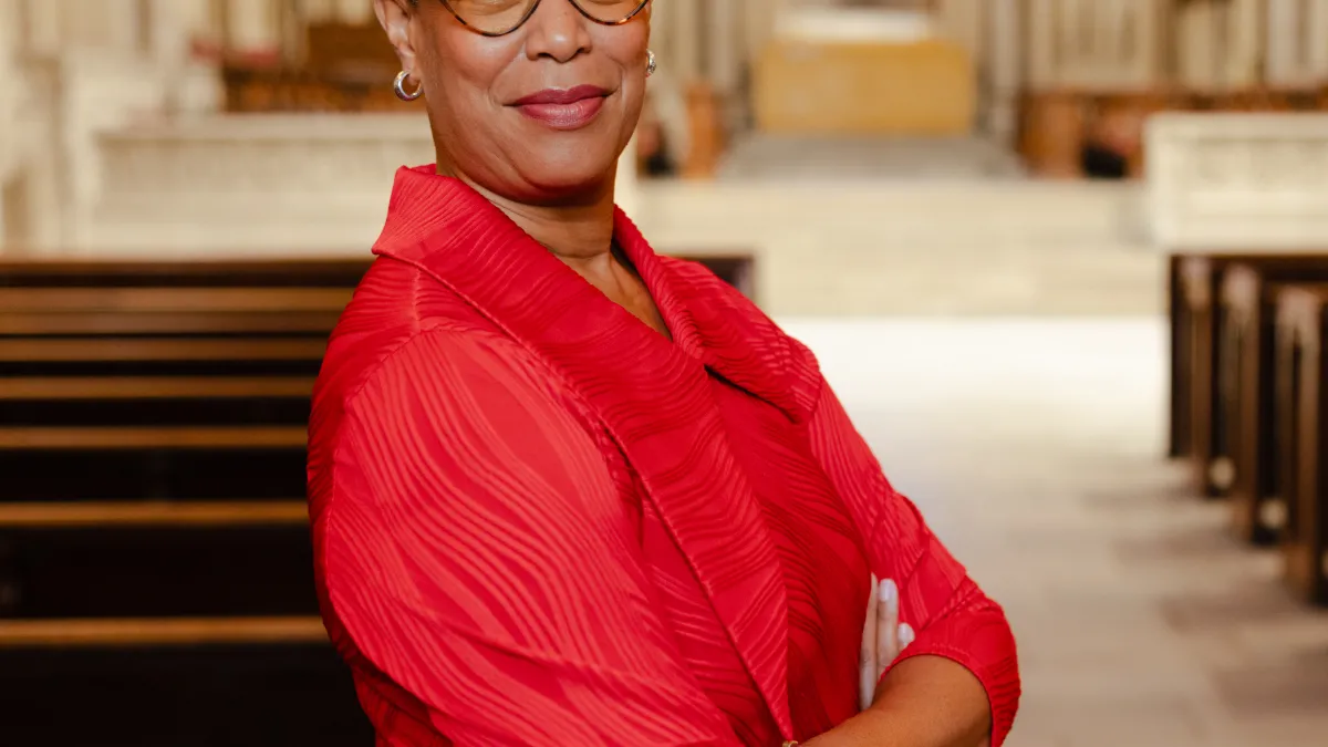 Picture of Adriene Thorne in a red dress standing in a church