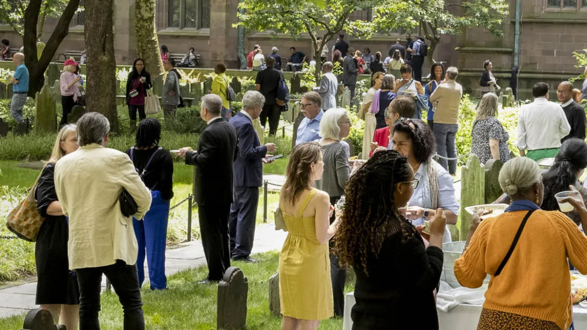 Trinity parishioners gathering for a picnic in the Trinity Churchyard