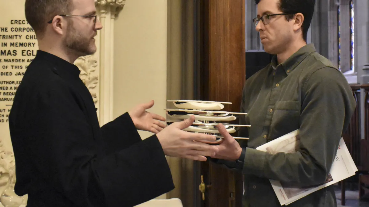 Assistant Head Sacristan Dane Miller works with a worship leader volunteer