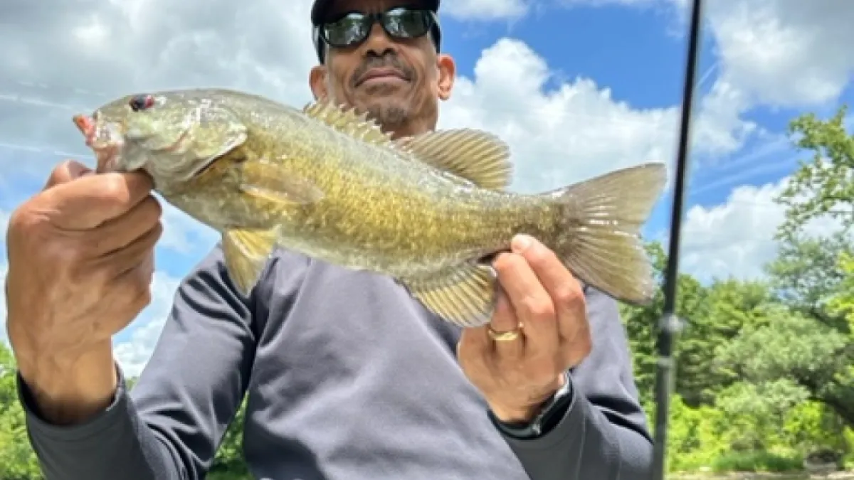 A guy is showing off his fish