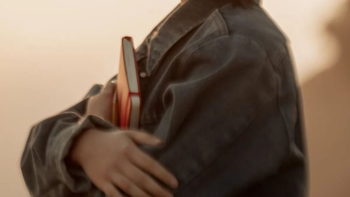 A girl is holding a book