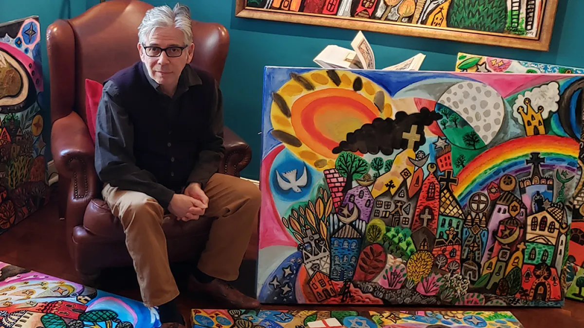 Brian Whelan with his paintings