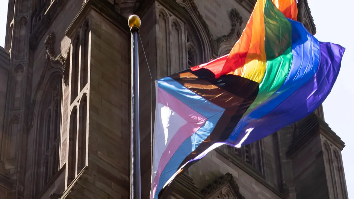 The pride flag with the church in the background