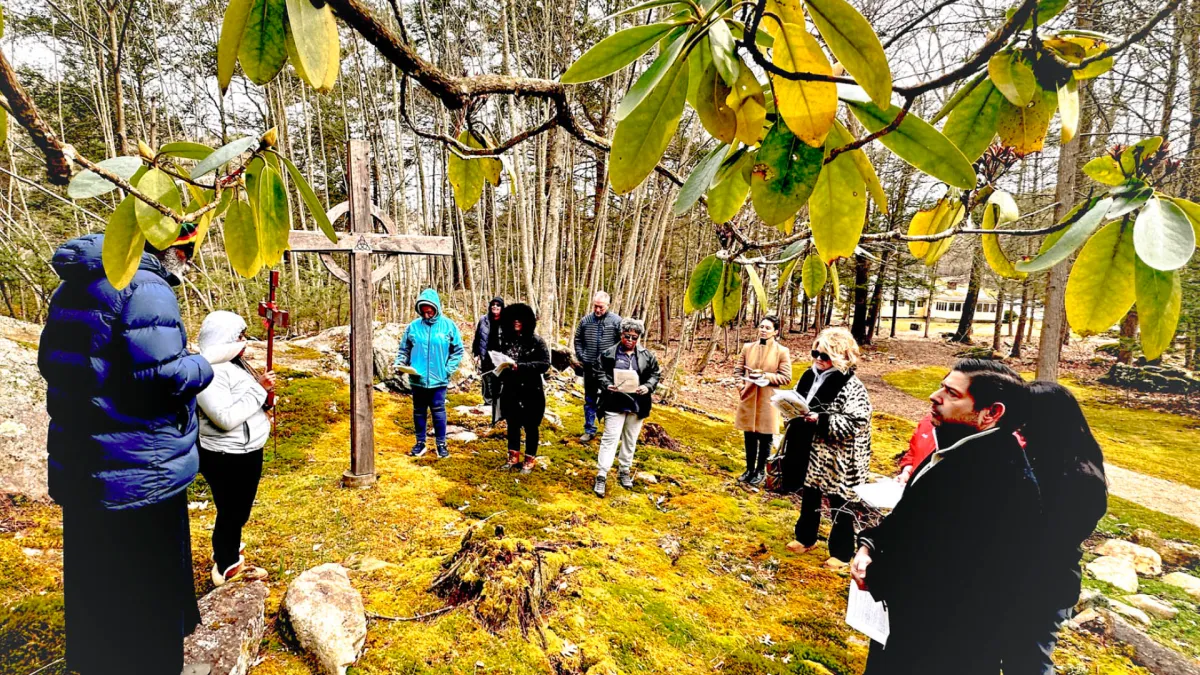 People pray in the woods