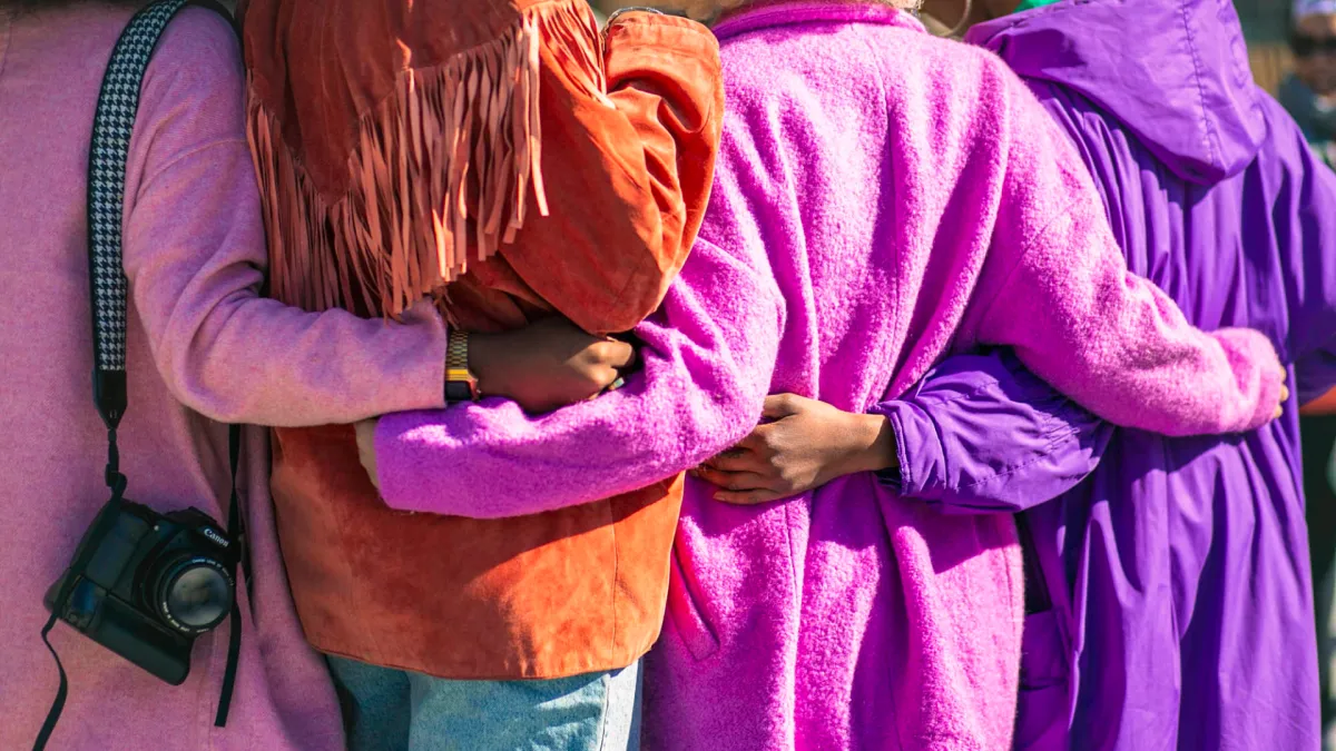 Women holding each other in the back