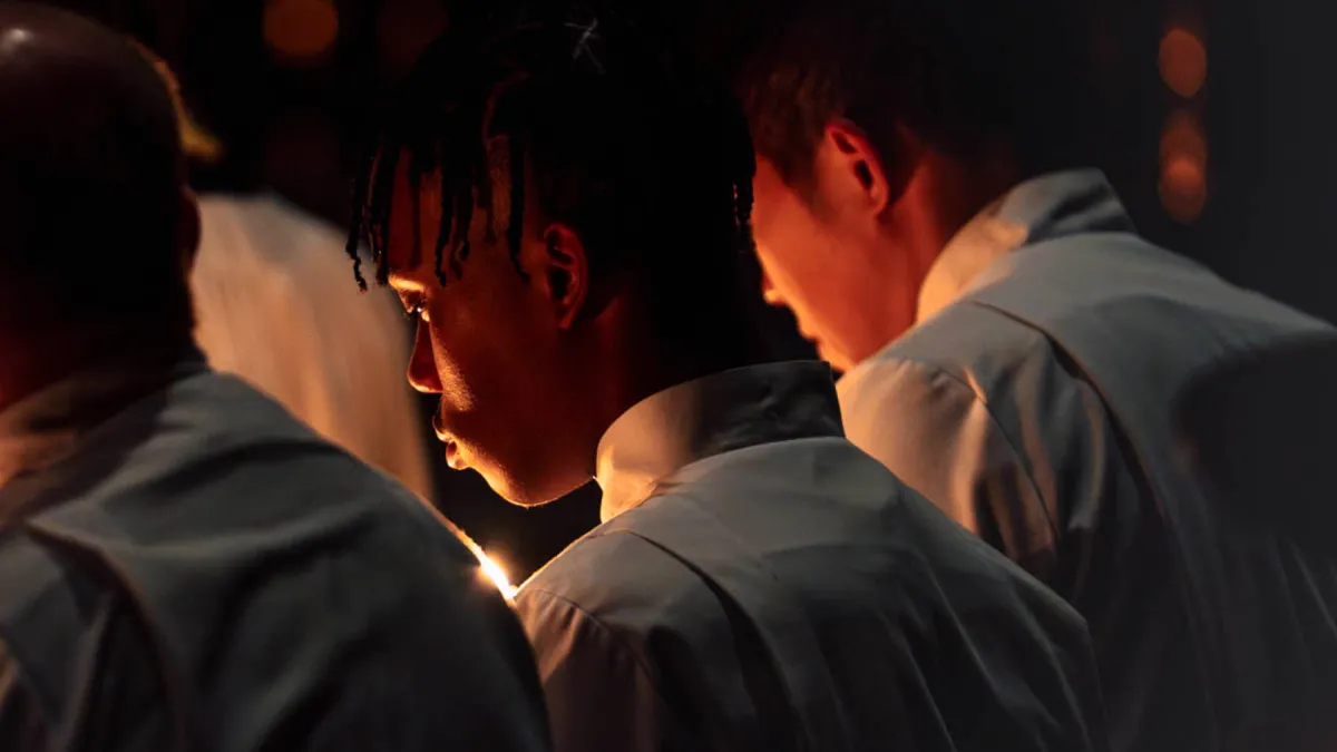 People pray in front of candle light