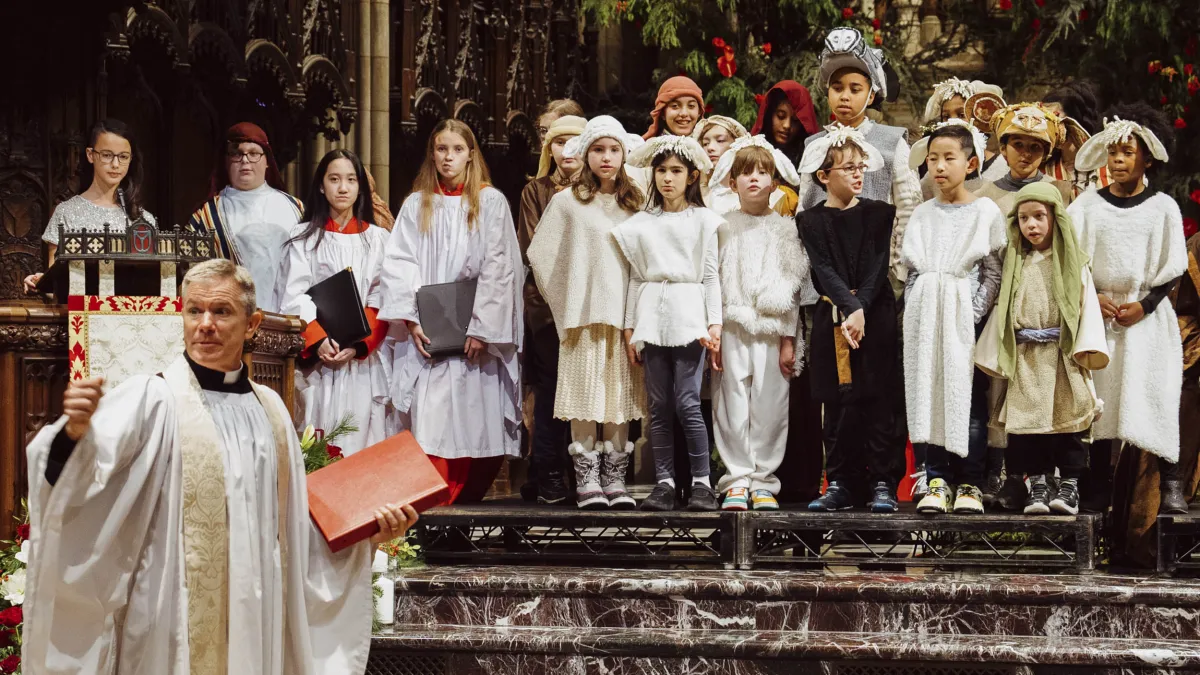 The kids line up with costumes at the altar. 