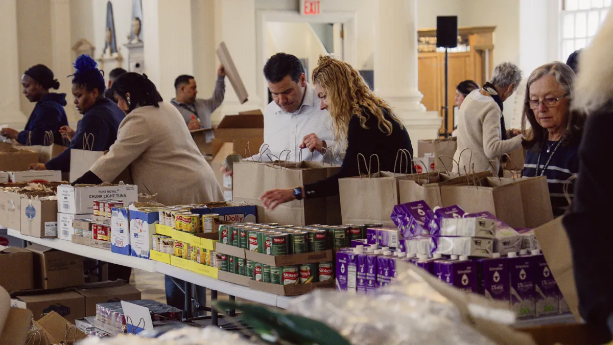 People pack groceries in St. Paul's Chapel