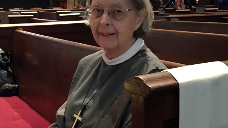 Sister Ann Whittaker sits in a pew at Trinity Church