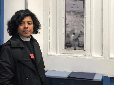 The Rev. Winnie Varghese bailing someone out