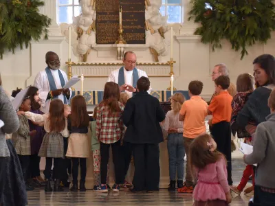 Children gather around the altar in St. Paul's Chapel