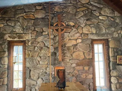 Trinity Retreat Center stone chapel is shown with light streaming in the windows