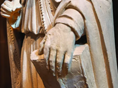 Detail of sculpture; hand holding book