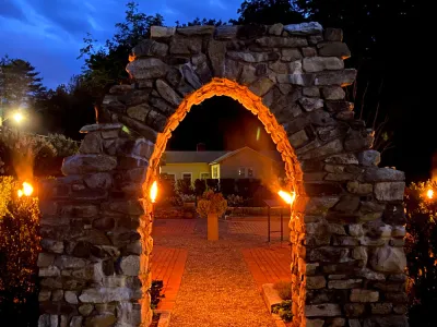 The top of the Retreat Center's stone arch in the early evening