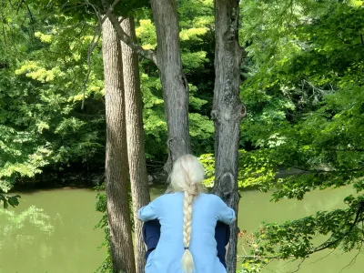 Woman with a braided ponytail overlooks the bank of the Housatonic River