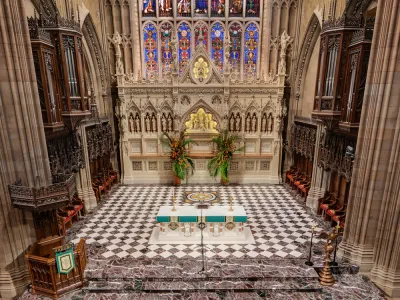 View of the chancel, alter and stained glass window of Trinity Church.